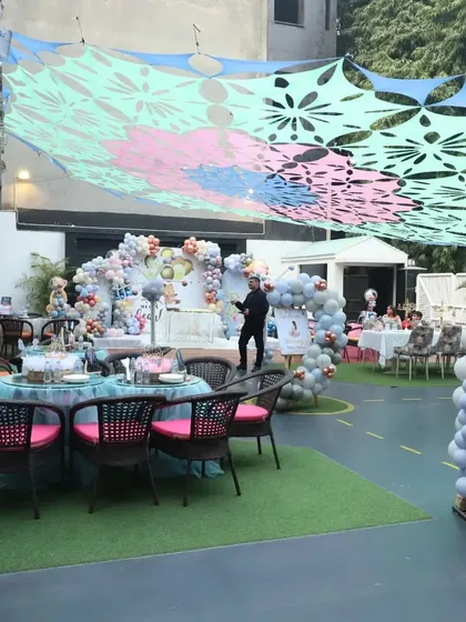 Here’s a wide view of our spacious outdoor lawn, all set up for a beautiful teddy bear themed party. You can see how I transform the space with grand balloon arches and comfortable seating for both kids and adults to enjoy the celebration.