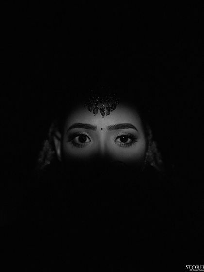 A dramatic black and white close-up of the bride's eyes, conveying deep emotion.