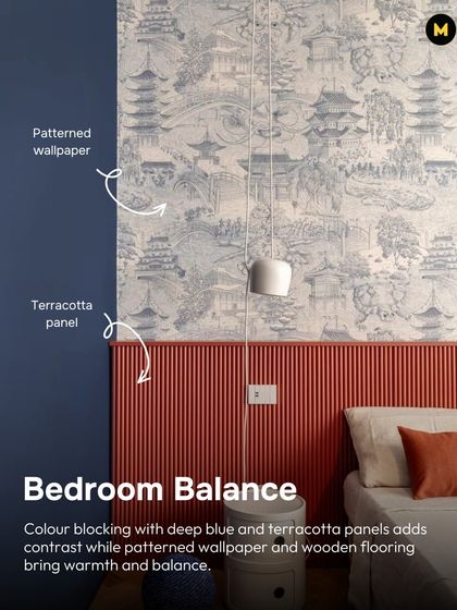 This bedroom achieves balance through color blocking. Deep blue and terracotta panels create a striking contrast, while patterned wallpaper and wooden flooring bring in warmth and texture.