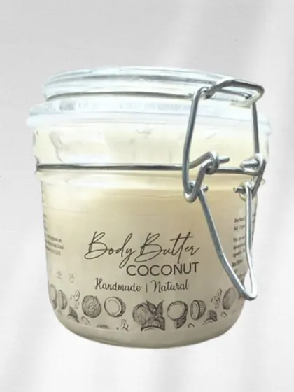Our Coconut Body Butter, presented in its beautiful and reusable glass jar. We are committed to packaging that is both elegant and eco-friendly.