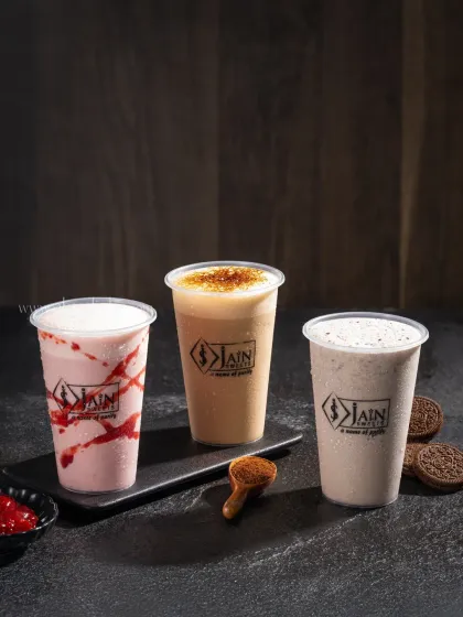 A trio of milkshakes: strawberry, coffee, and Oreo, showcasing a variety of popular flavors for Jain Sweets.