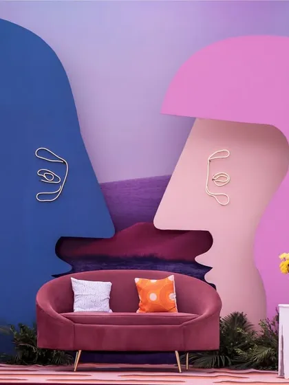 A bold and artistic seating backdrop from our 'Art in the City' carnival theme. Inspired by modern art, these abstract face silhouettes create a visually striking and interactive space for guests.