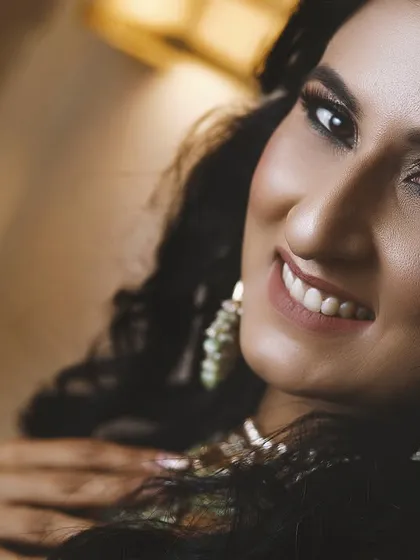 A stunning close-up portrait of the bride-to-be, highlighting her beautiful makeup and joyful expression.