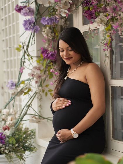 A quiet, contemplative moment. The one-shoulder style of the Zelda gown is modern and elegant.