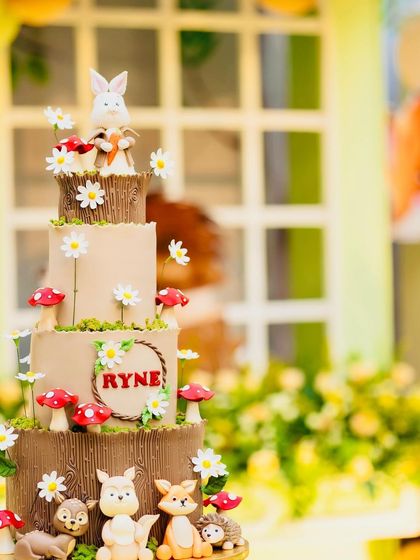 Another beautiful shot of Ryne's woodland cake, highlighting the intricate details of the fondant animals and the delicate sugar flowers.