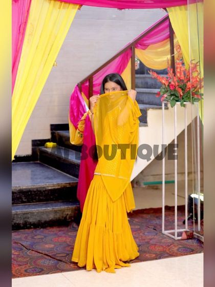 A playful shot of a client in her yellow sharara suit, perfect for a Haldi or Mehndi function. The color is so bright and cheerful.