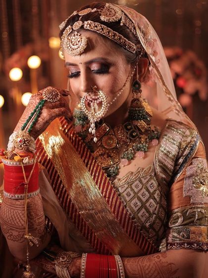 A close-up of the bride's nath and the intricate details of her jewellery.
