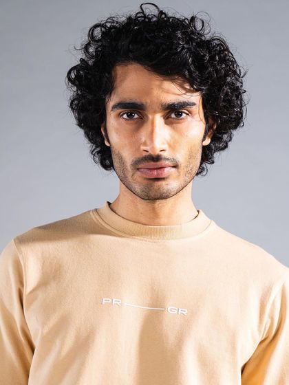 This headshot from a fashion campaign highlights our expertise in men's grooming. The focus is on natural-looking skin and well-defined curls for a confident and polished result.