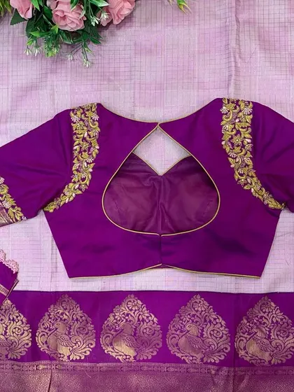 A purple silk blouse with a heart-shaped keyhole back. The shoulders and sleeves are adorned with delicate gold embroidery.