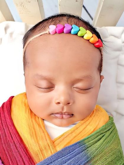 A close-up on the baby's face and the colorful headband.