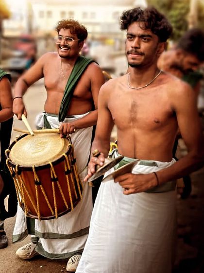 A smile is the best accessory. Our artists enjoying the performance, one playing the chenda and the other on ilathalam cymbals.