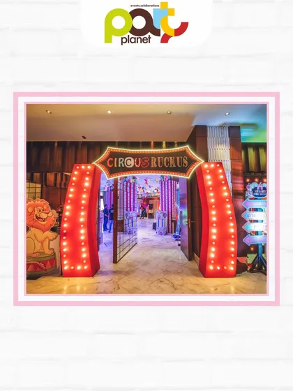 The grand, brightly lit entrance to a "Circus Ruckus," inviting guests into a world of fun and excitement.