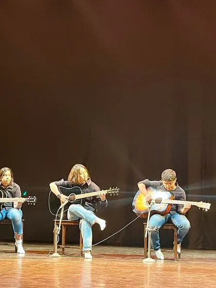 From the practice room to the spotlight. Our guitar students command the stage during our annual 'Sarvaang' showcase, performing a musical medley for a live audience. We ensure every student gets the chance to experience the thrill of a real performance.