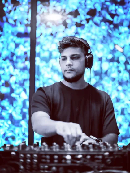 A shot of me at the decks with a cool blue visual backdrop, demonstrating how I can set different moods with my VJ skills.