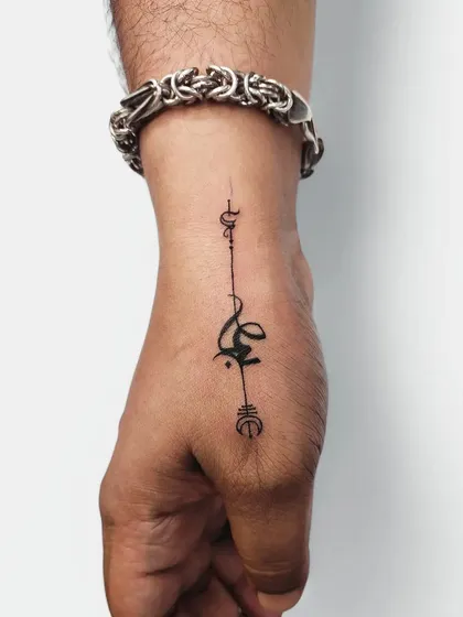 A custom, abstract symbol on the hand. We love working with clients to create unique designs that are entirely their own.