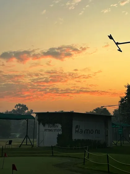 A beautiful sunset over the Fitting Studio, with vibrant orange and pink clouds.