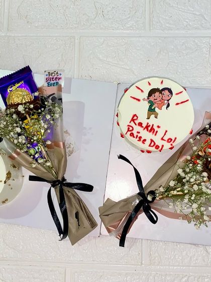 A look at two of our Rakhi hamper options, one with a "Happy Rakhi" message and the other with a funny "Rakhi Lo, Paise Do" doodle.