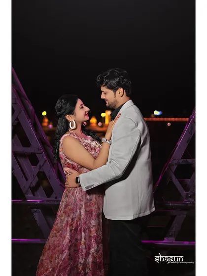 A sweet embrace on the bridge at night, with the purple lighting adding a touch of modern romance. This shot is all about their happy connection.