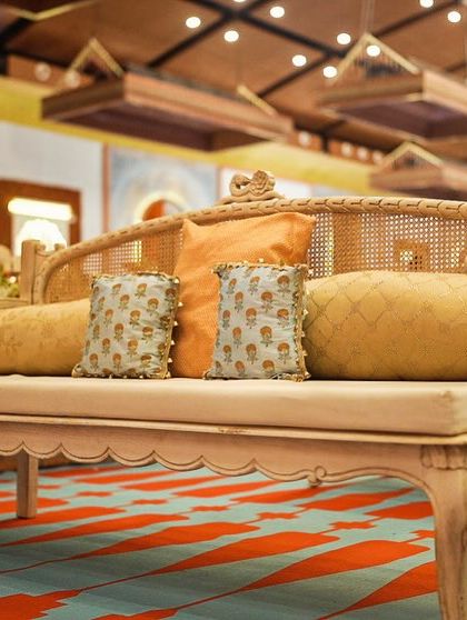 The custom-designed furniture for the South Indian wedding, featuring elegant lines and cushions in our theme colors of powder blue and orange.