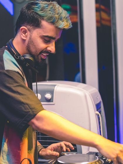 A close-up showing my focus while DJing. The colorful hair reflects the vibrant and playful energy I bring to my sets.