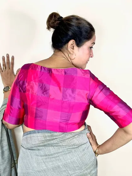 My Pink Checks Blouse is a blend of tradition and trend. Here, it's paired with a simple grey saree for a modern, elegant look.