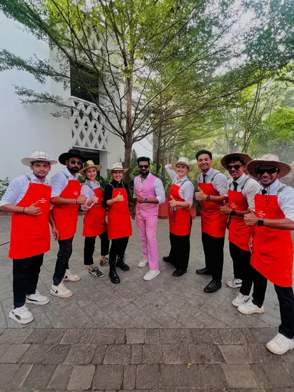 The team, led by me in the pink suit. We coordinate our looks but let our individual personalities shine, creating a dynamic and engaging bar experience.