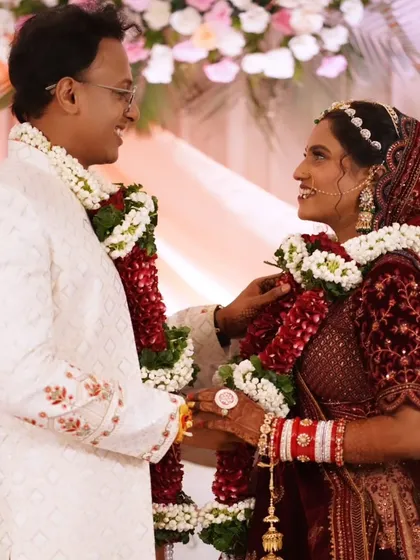 A candid shot of the couple sharing a look during the varmala ceremony. The bride's natural-looking makeup enhances her beauty.