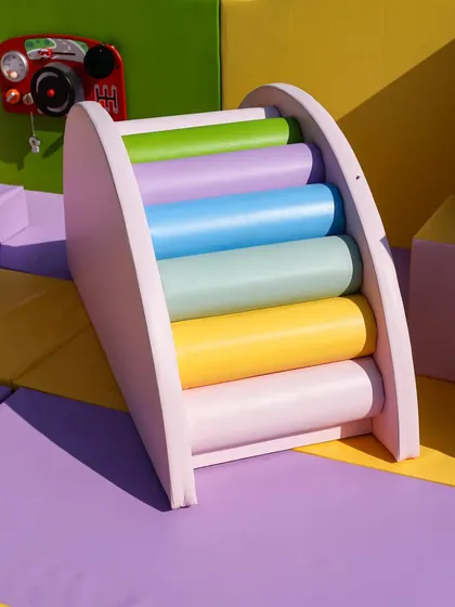 A close-up of the rainbow climber, showing the soft, rounded foam rollers that are perfect for little hands and feet.
