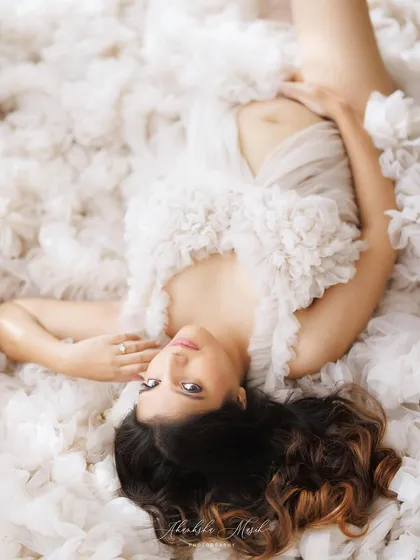 An artistic overhead shot capturing the ethereal quality of this ruffled white gown, creating a portrait that feels like a dream.