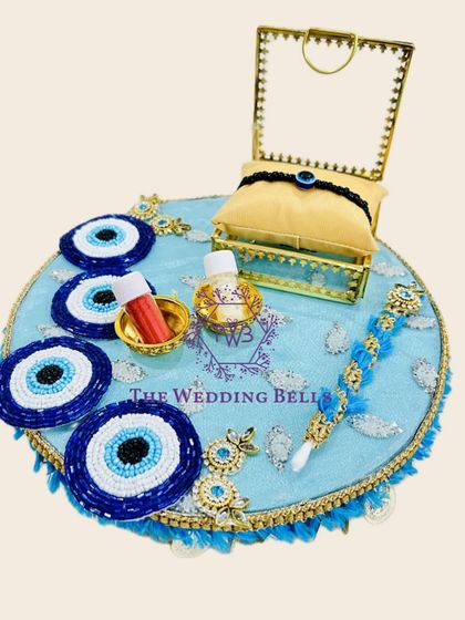 Protect your bond with this evil eye-themed Rakhi tray. The beautiful blue and white beading adds a unique and meaningful touch.