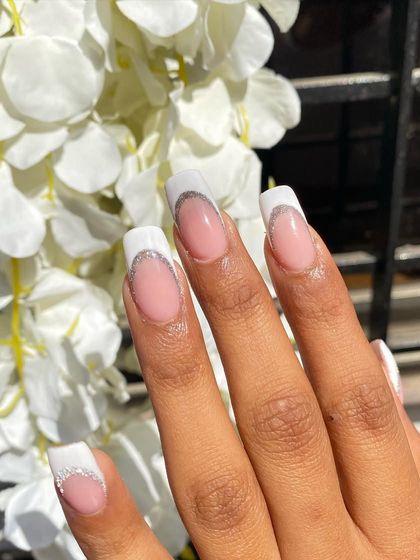 Another look at the elegant French manicure with a glitter twist. The square nail shape gives it a modern feel, while the design remains timeless and chic.