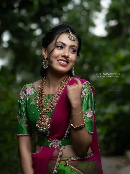 This side profile highlights the soft, romantic hairstyle that complements the modern lehenga. We teach a variety of contemporary hairstyles that work beautifully with modern Indian wear.