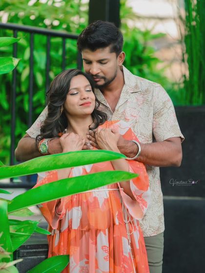 A relaxed and stylish poolside shoot. The lush green surroundings and calm water provide a beautiful, resort-like setting for casual and romantic couple photos.
