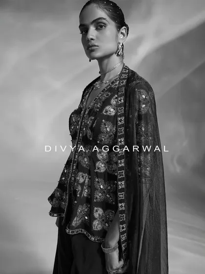 An artistic black and white portrait showcasing an embellished peplum top. This style of photography allows the intricate details and modern silhouette to take center stage.