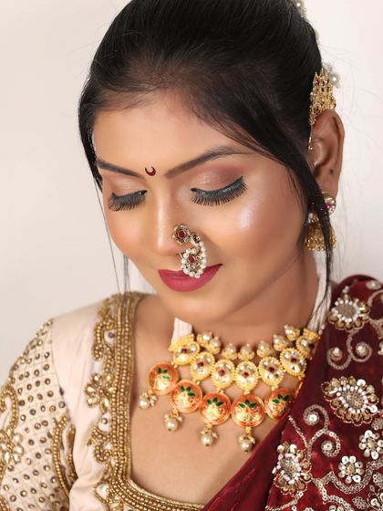 This shot focuses on the bridal makeup and the traditional choker necklace.
