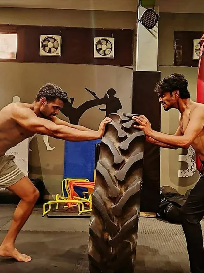 Strength isn't just for show; it's for survival. In my combat fitness sessions, we build functional power with drills like tire flips that prepare your body for the explosive demands of a real fight. This is how you become a harder target.