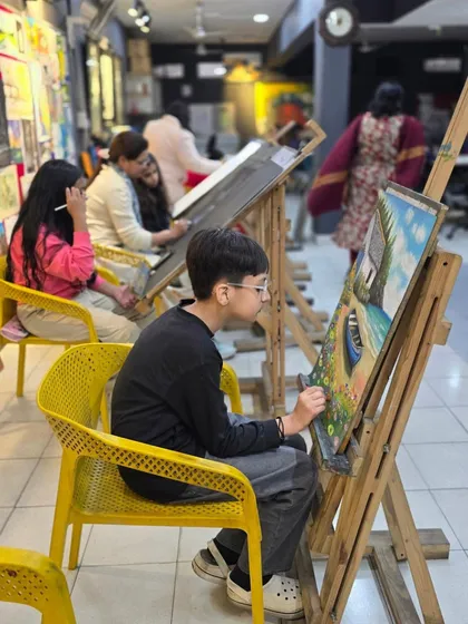 A wider view of the studio, showing students of different ages working on their projects. We foster a diverse and inclusive community of artists.