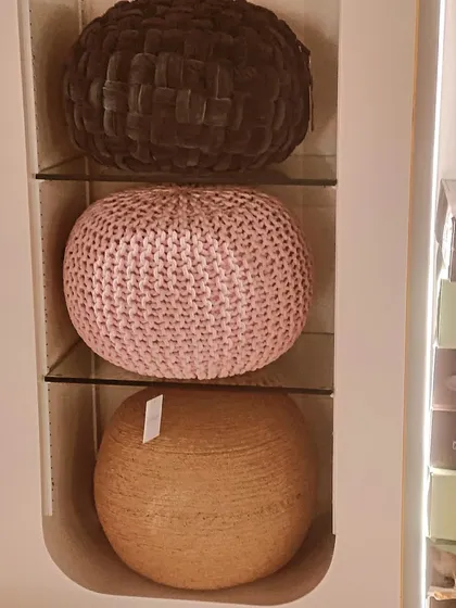 We have a variety of poufs and ottomans available, including knitted, woven, and fabric designs to add texture and comfort to your room.