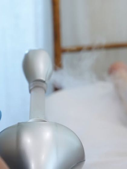 A focused shot of the facial steamer nozzle, delivering a cloud of warm mist. This relaxing step prepares the skin for deeper cleansing and better product absorption.