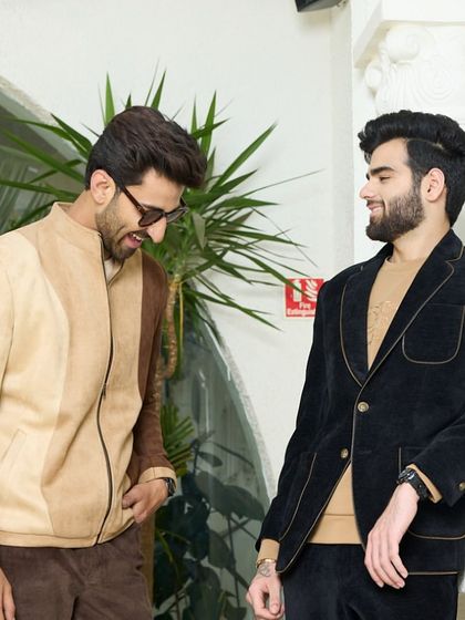 This image highlights the contrast between a navy velvet blazer and a beige suede jacket. Both pieces exemplify my commitment to using premium fabrics to create garments with undeniable style.