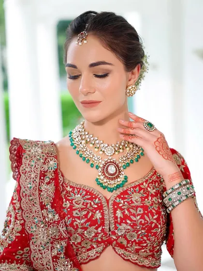 A close-up with eyes closed, highlighting the soft, blended smokey eye. This technique adds definition and drama without being heavy, perfect for a classic bridal look.
