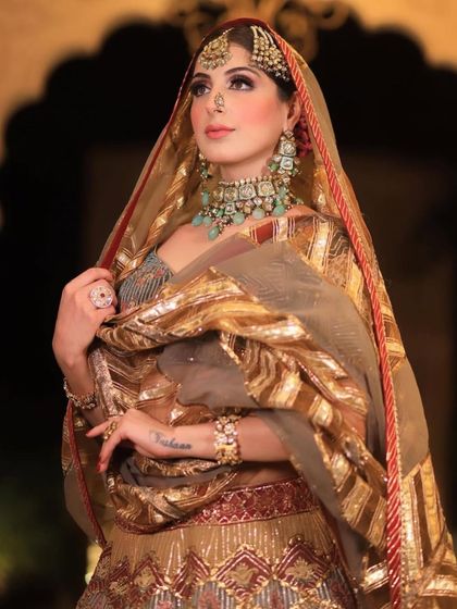 A close-up of the royal bride, showing the intricate details of her passa, nath, and layered necklace.