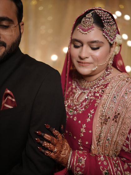 A tender moment between the Nikkah couple. The bride's makeup is soft and romantic, with a focus on glowing skin and defined eyes.