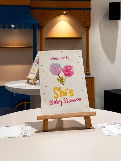 A personalized welcome sign on a mini easel for Shi's baby shower. These small, custom touches on each table help carry the theme throughout the entire event space.