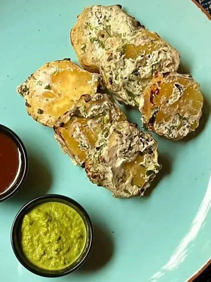 Experience the smoky, spicy flavors of Rataloo Tikka Tandoori. Sweet potatoes are marinated in aromatic spices and grilled to perfection in our tandoor for a delicious starter.