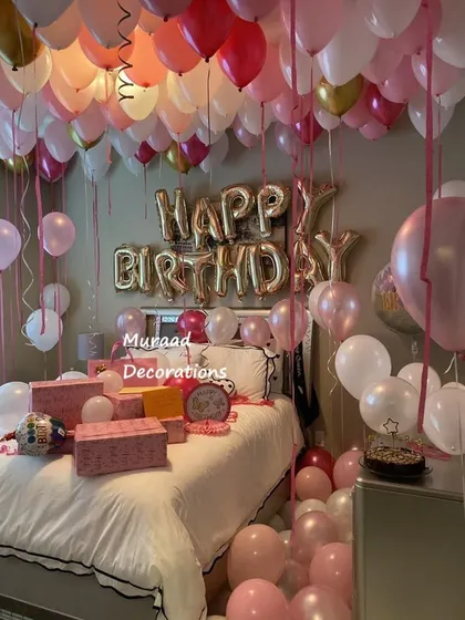 This room is filled with balloons for a grand birthday surprise. The ceiling is covered in pink, white, and gold balloons, creating a dreamy and immersive celebratory atmosphere.