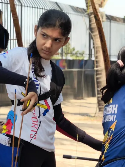 A young girl preparing her arrow, her focus unwavering. We are proud to see so many talented girls joining the sport.