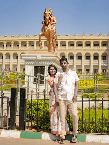 A pre-wedding photo taken at a significant local landmark, adding a personal touch to the couple's album.