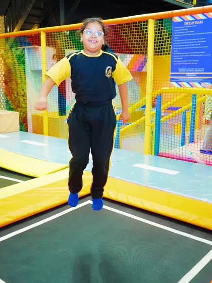 A student from Kanha Makhan Millennium School enjoys the trampoline zone during their exciting school trip.