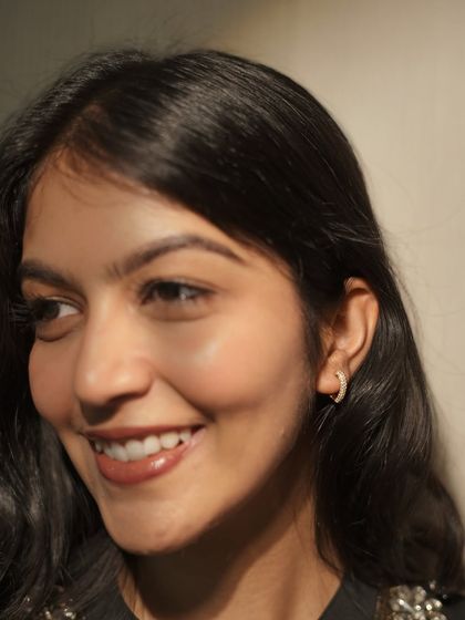 A close-up on these minimal diamond hoop earrings. They are the perfect everyday accessory to elevate a simple college or casual outfit.